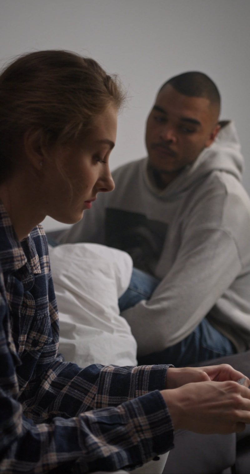 A Sad Couple Sitting in a Room