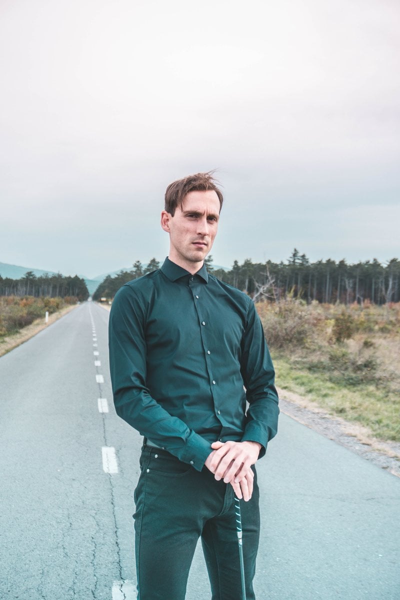 A Serious Man in Black Long Sleeves Looking at Camera while Standing on the  Road &middot; Free Stock Photo