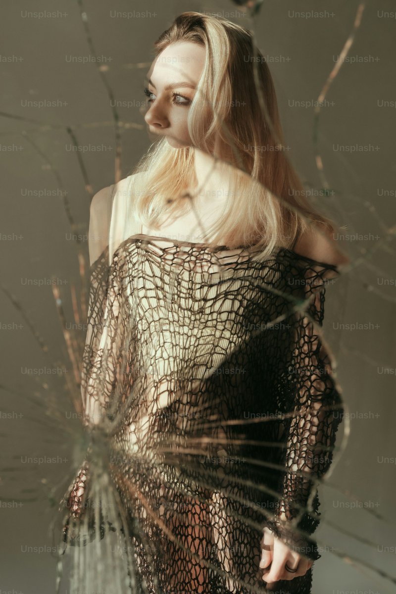 A woman standing in front of a broken glass window photo &ndash; Green Image on  Unsplash