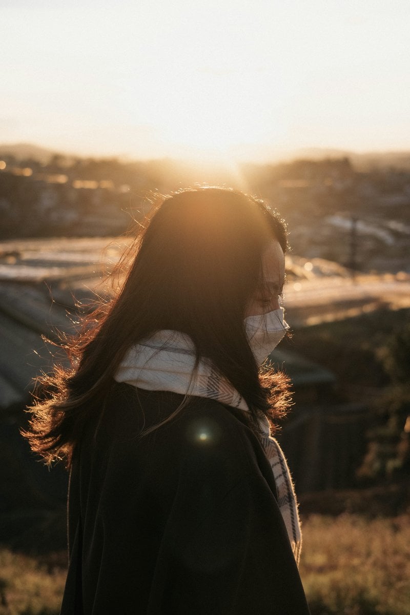 A woman with long hair wearing a face mask photo &ndash; Free ...