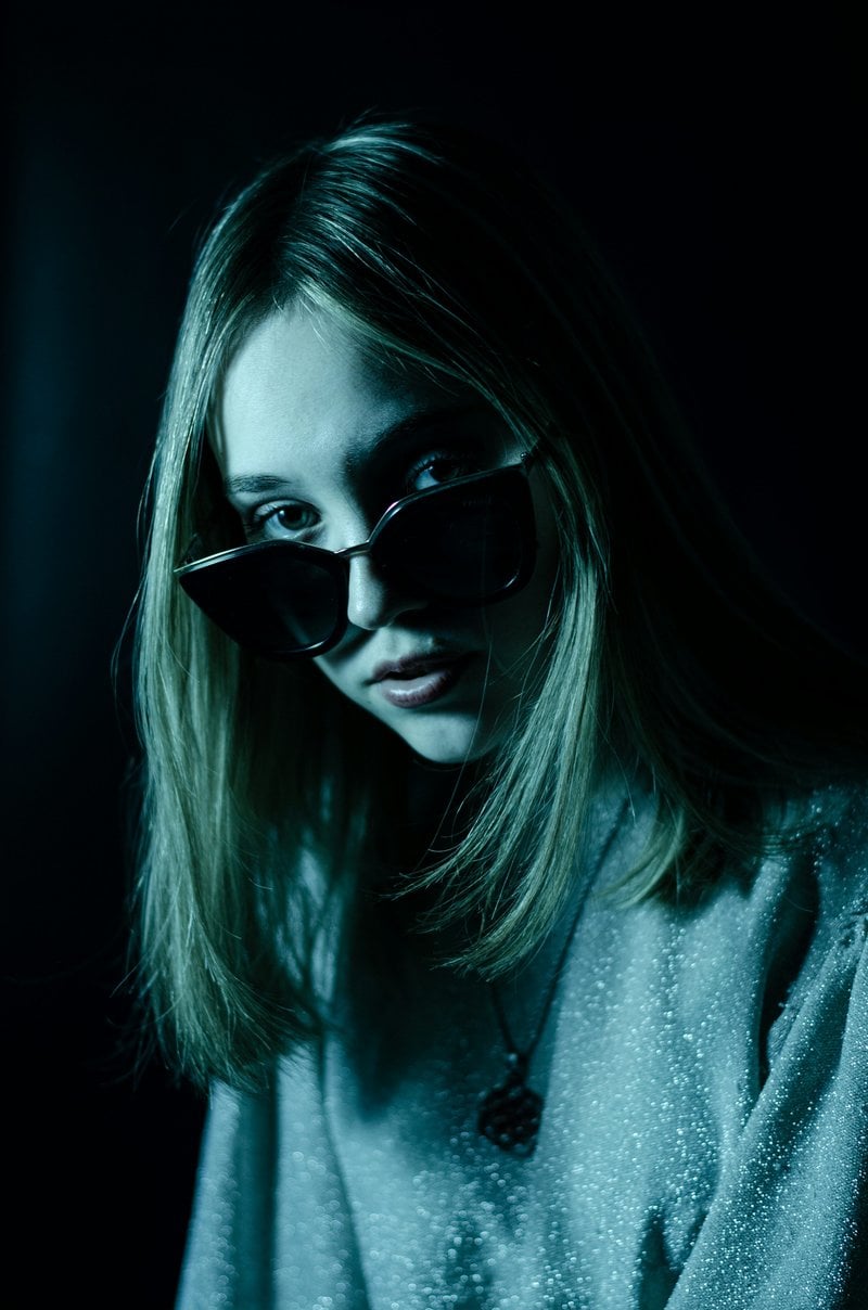 A woman with sunglasses on her face in the dark - Free Photo on Unsplash