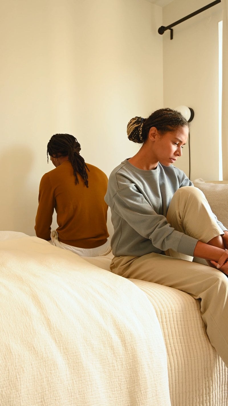 An Upset Couple Sitting on the Bed