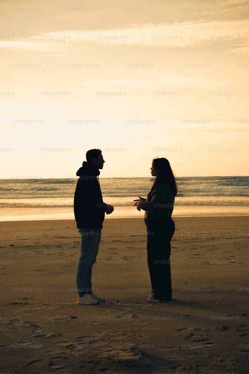 Couple talking on a beach at sunset photo &ndash; Portrait Image on Unsplash