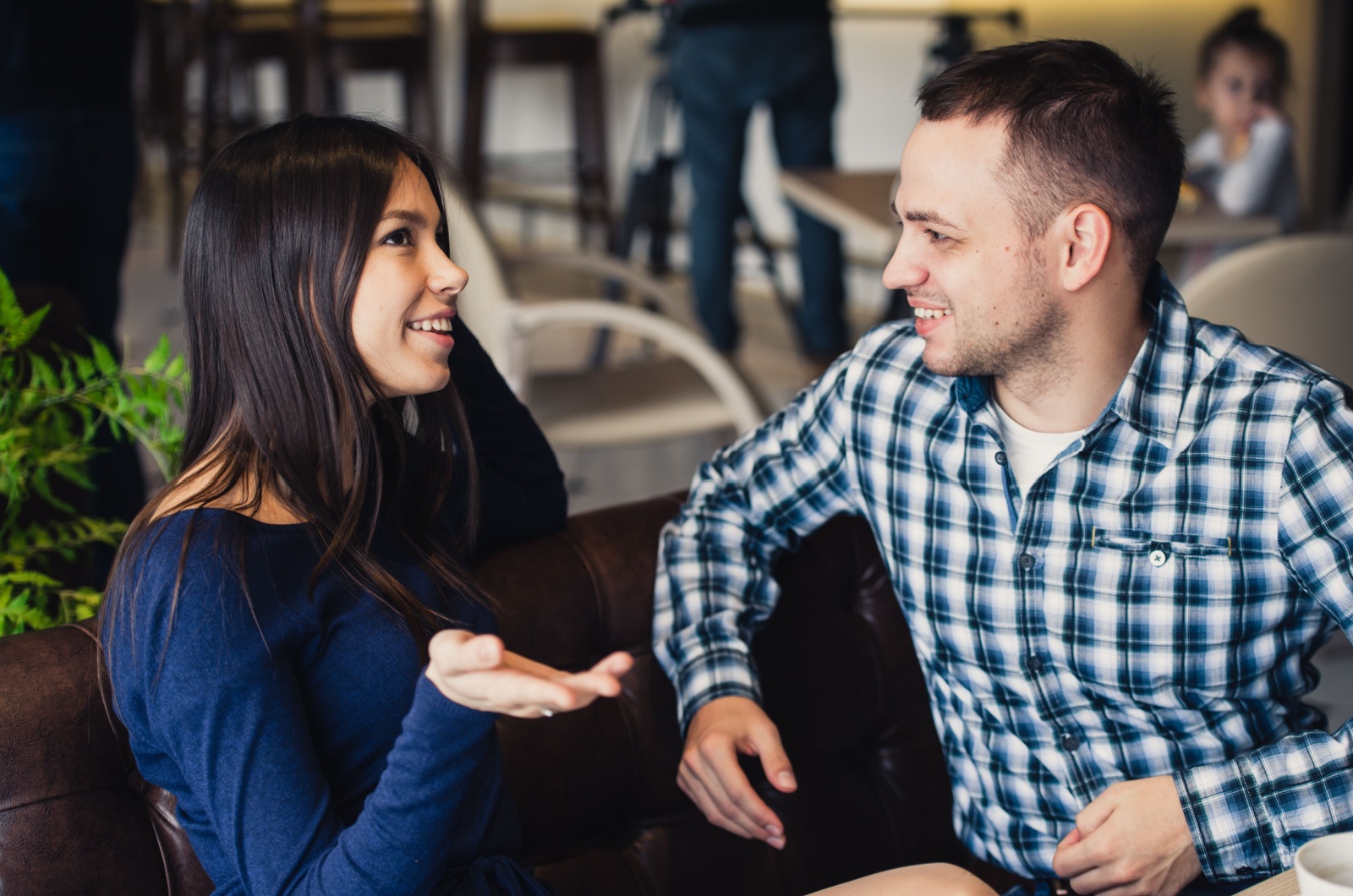 Happy couple talking at cafe