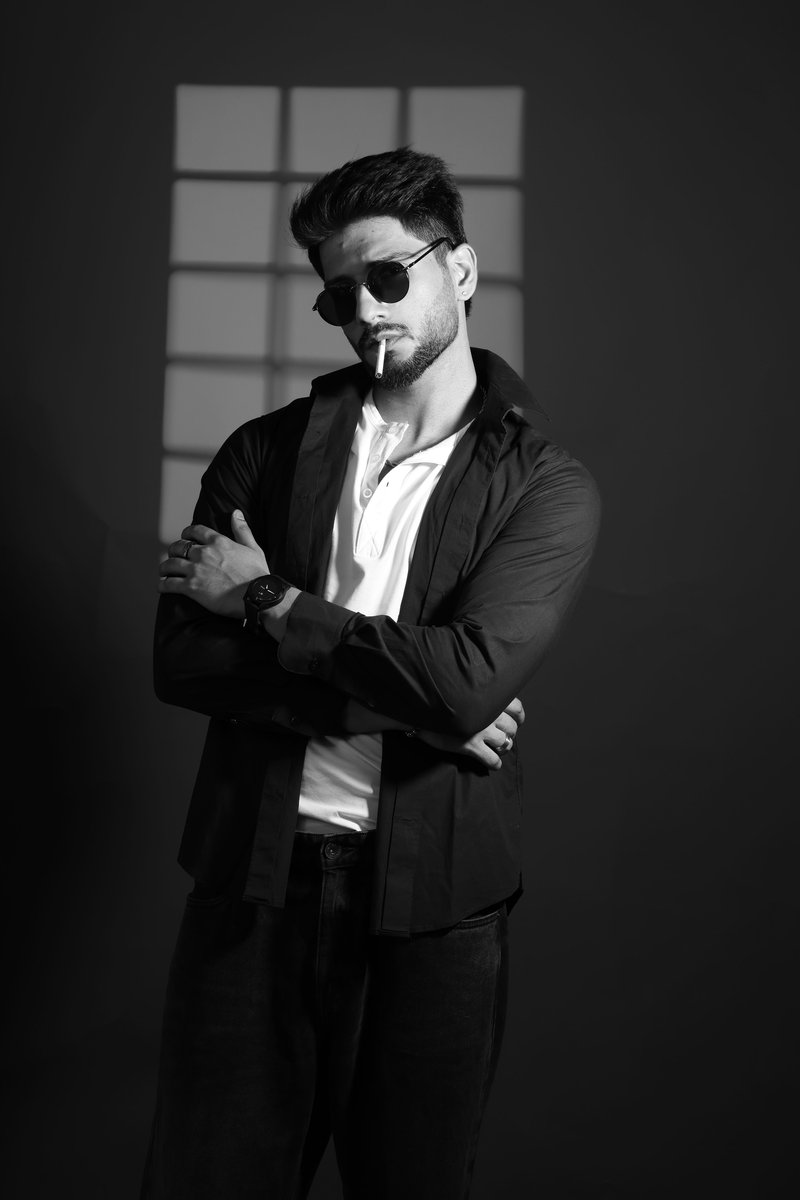 Stylish man with sunglasses and cigarette against a dark background. photo  &ndash; Free Watch Image on Unsplash