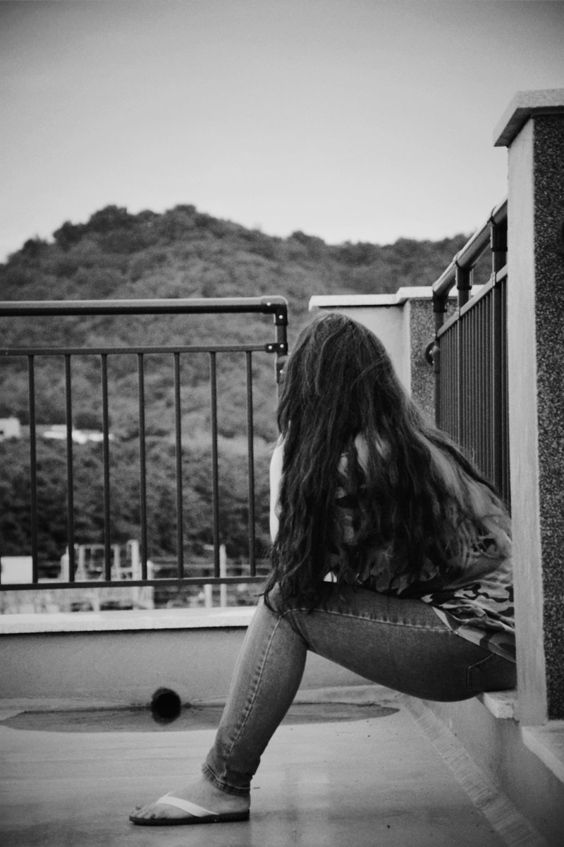 Woman Sitting Alone on Balcony &middot; Free Stock Photo