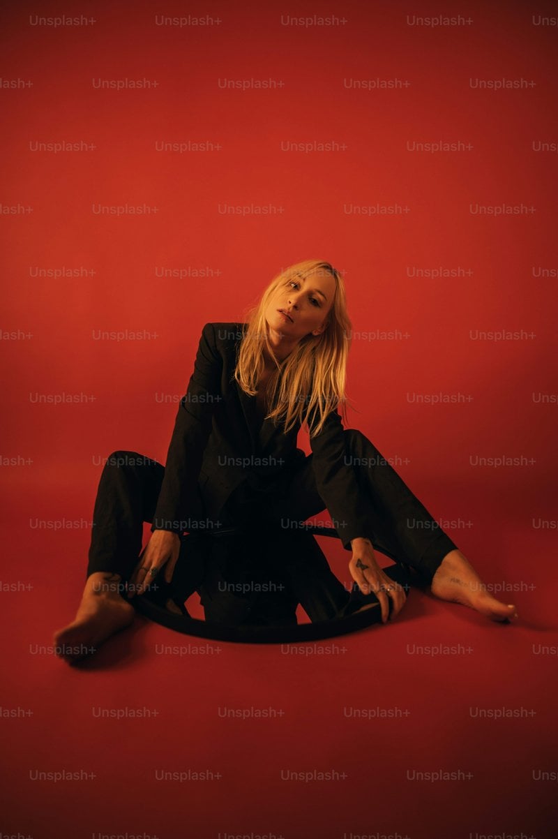 Woman in black long sleeve shirt lying on red couch photo ...