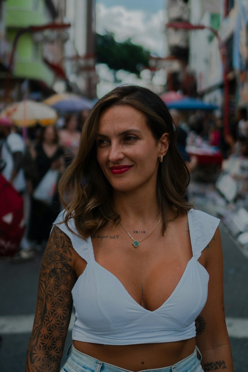 Woman with tattoos and red lipstick in a busy street photo &ndash; Free Necklace  Image on Unsplash
