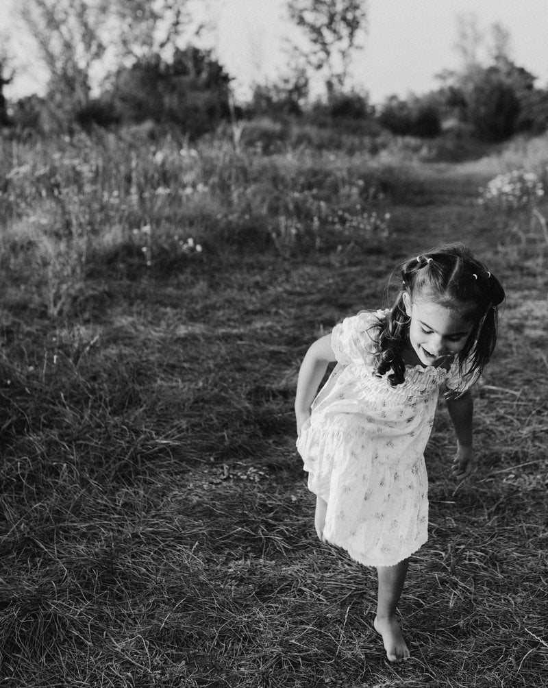 A little girl in a dress is running through a field - Free Photo on Unsplash