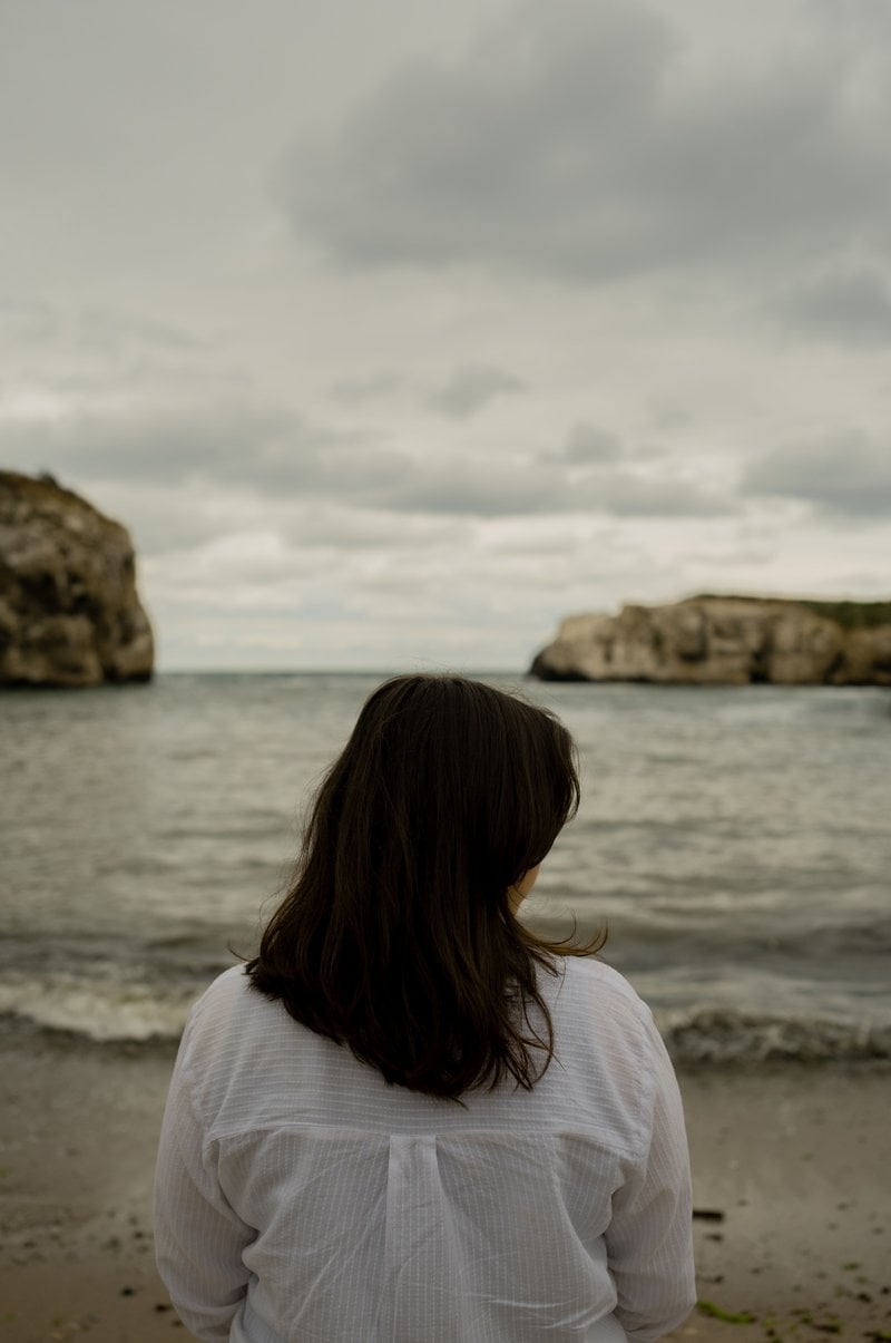 Back of a Woman Standing Alone on a Beach &middot; Free Stock Photo