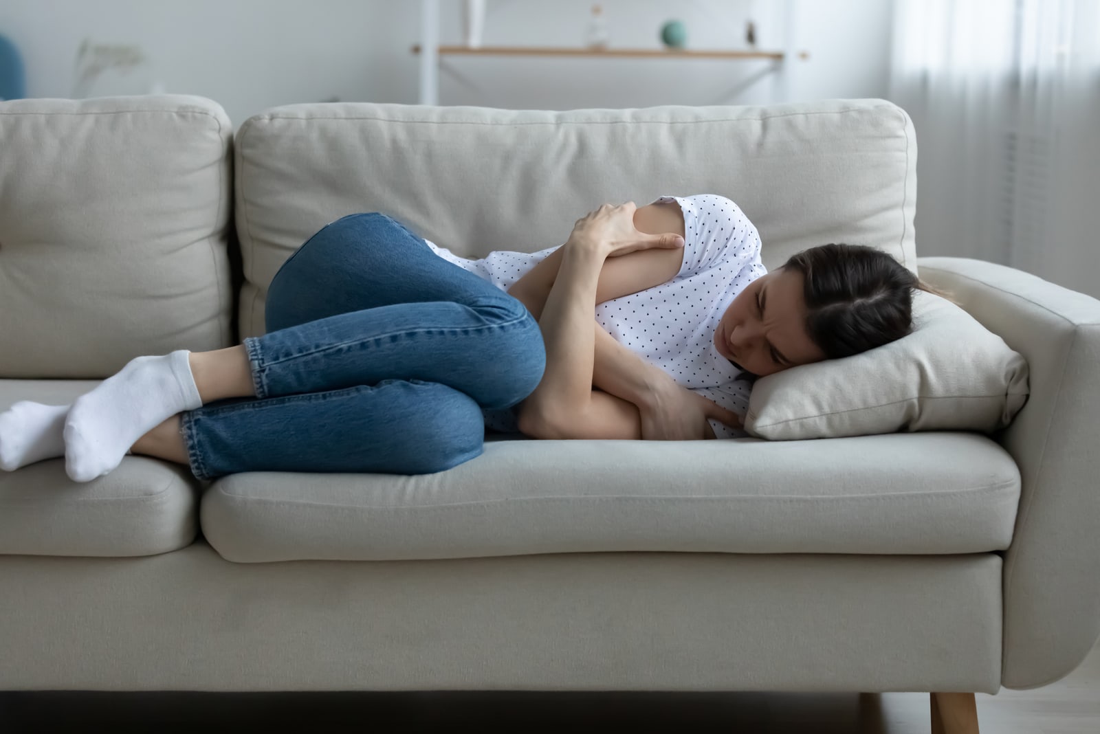 sad woman lying on the couch