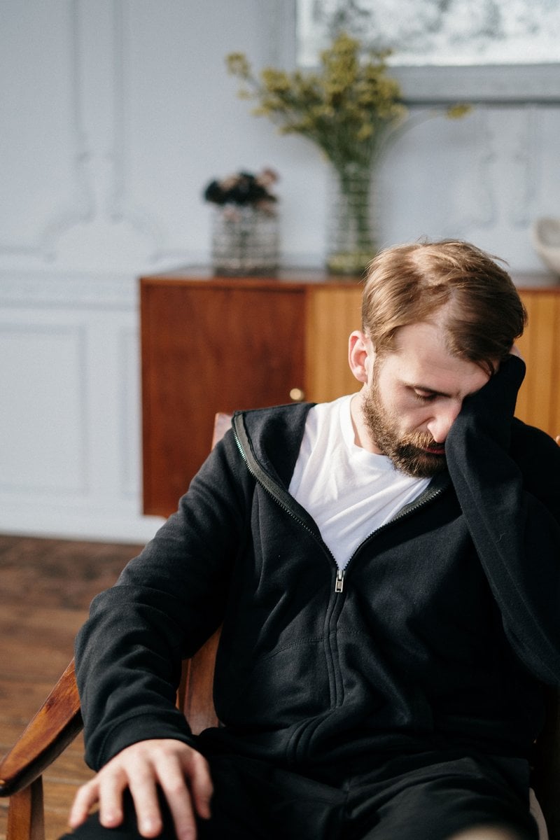 A Distressed Man Sitting on a Couch &middot; Free Stock Photo
