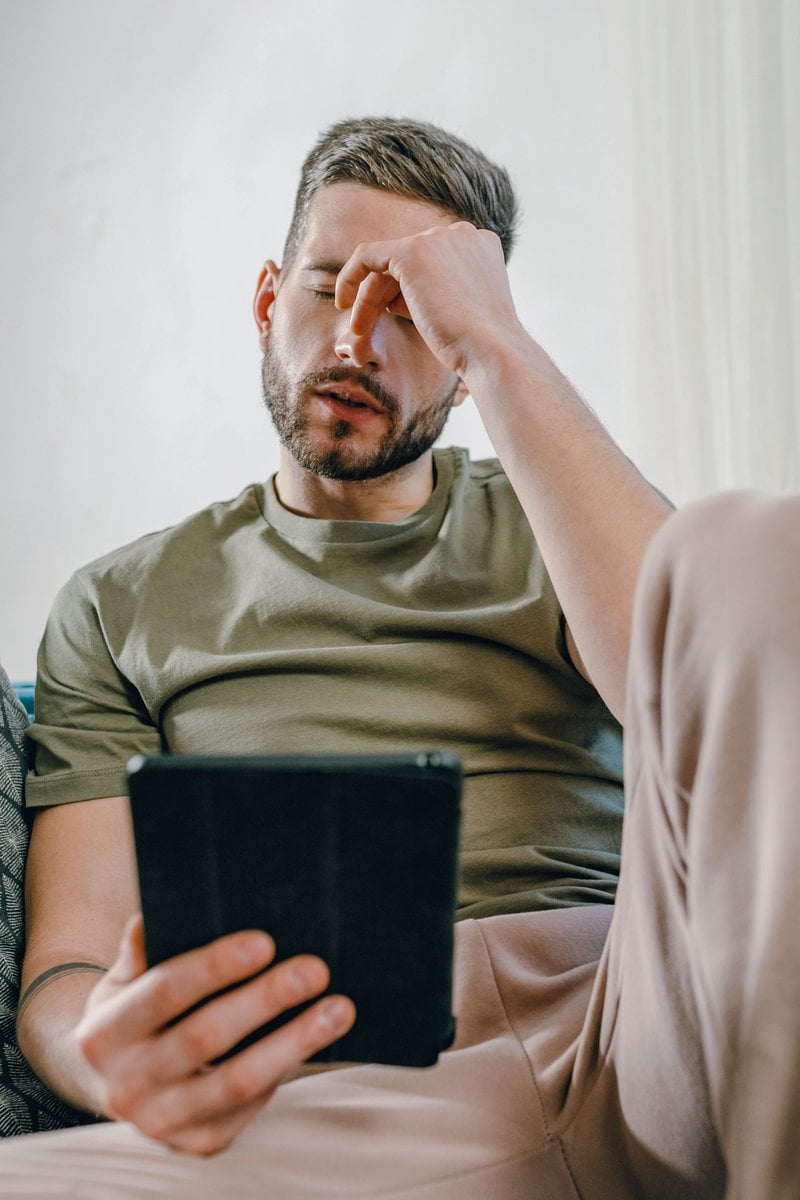 A Distressed Man Sitting on a Couch &middot; Free Stock Photo