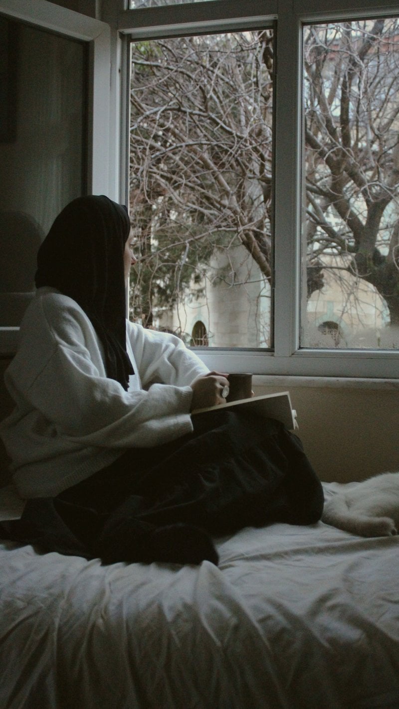 Woman in Hijab Sitting on Bed by Windows &middot; Free Stock Photo