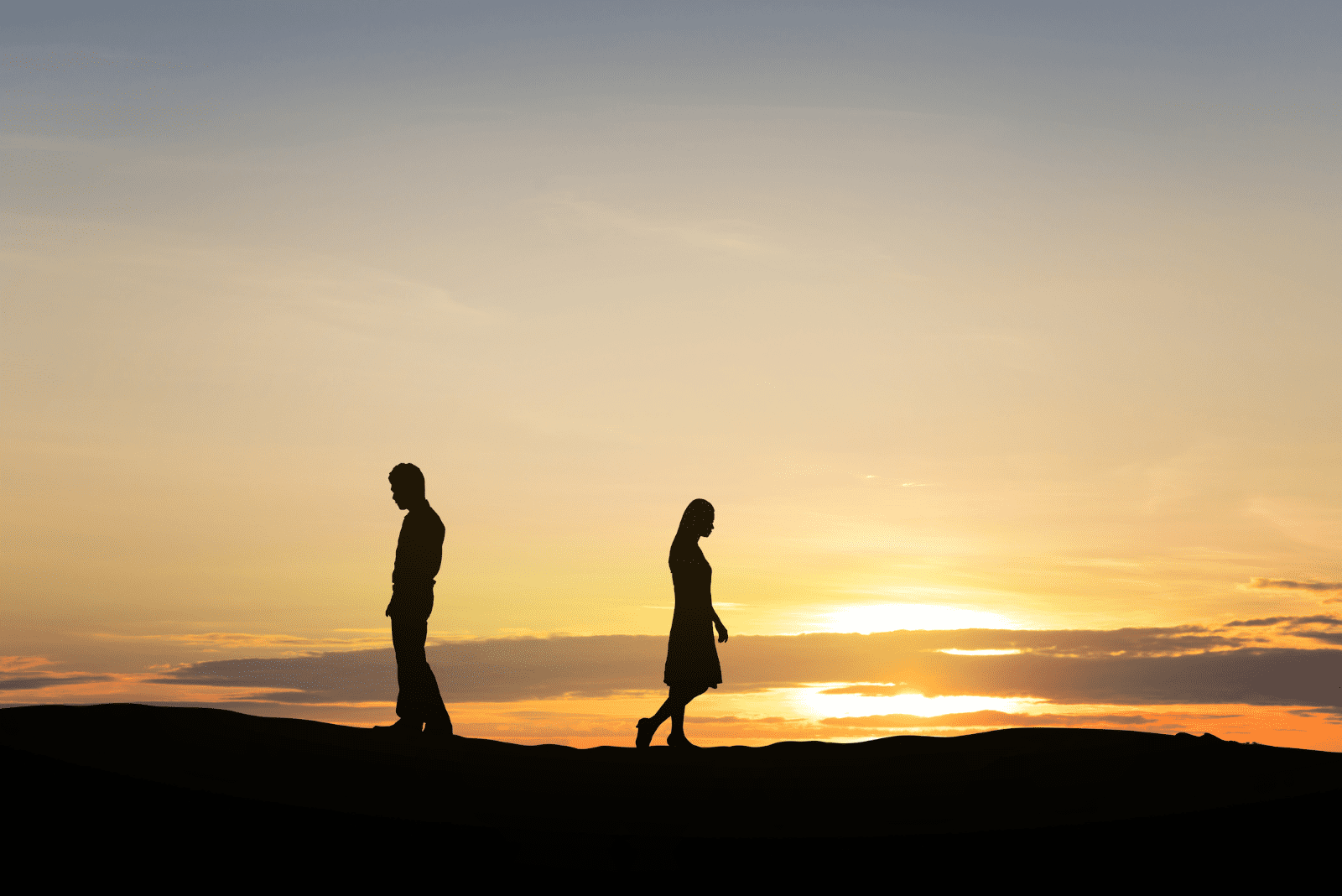 a man and a woman walk away from each other